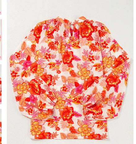Orangefarbene Bluse mit Puffärmeln und Blumenmuster