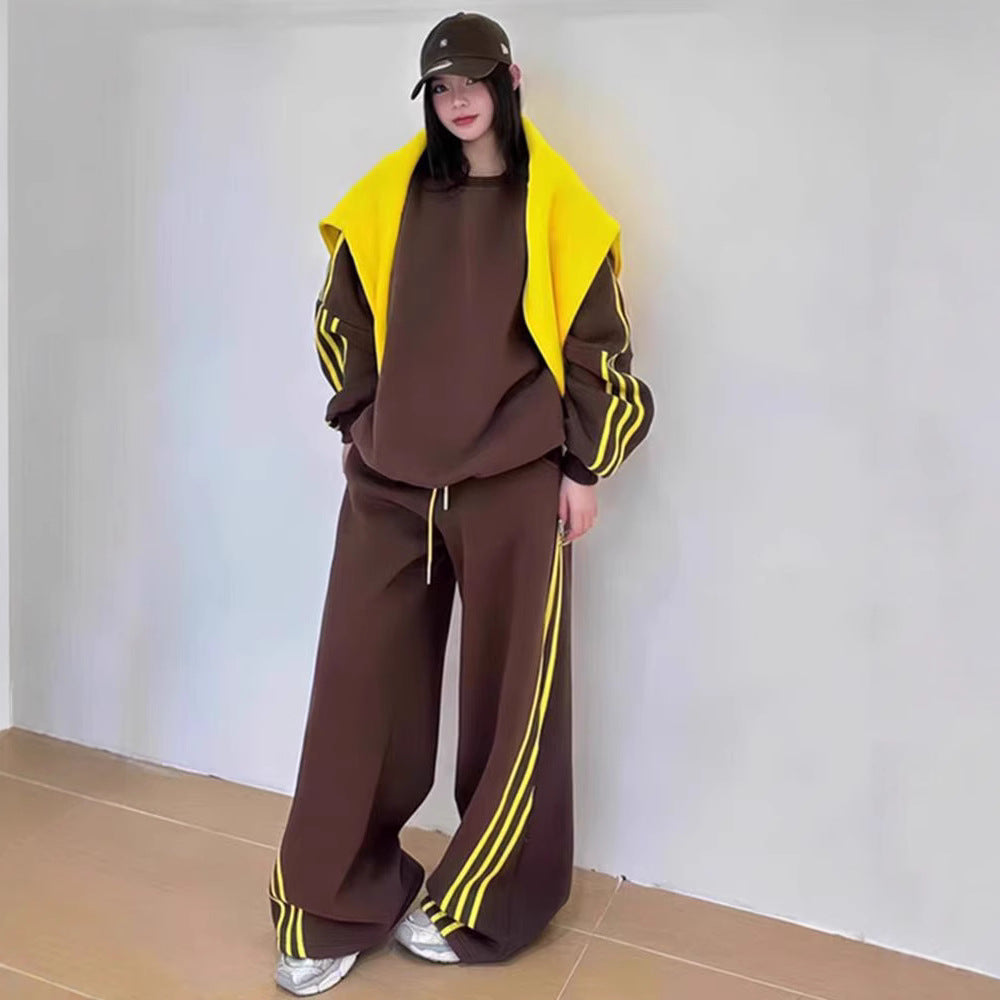 Person wearing a brown and yellow tracksuit against a plain background