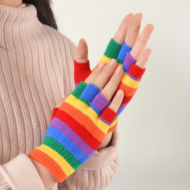 Rainbow striped fingerless gloves worn by a person against a neutral background