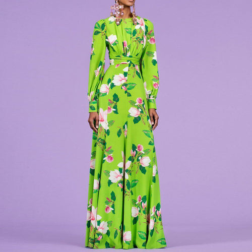 Woman wearing a green floral dress against a purple background