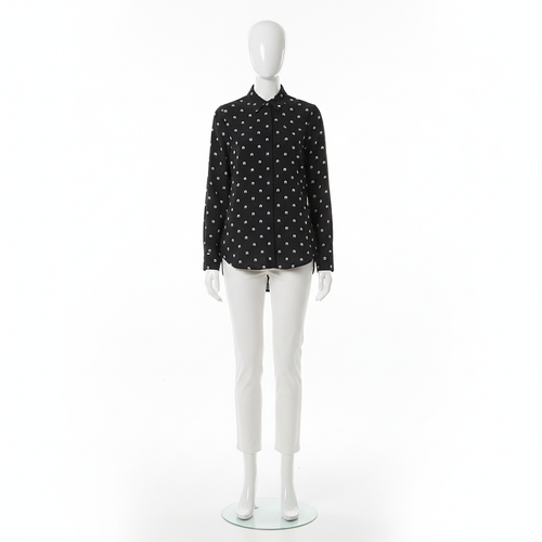 Mannequin wearing a black shirt with white polka dots on a white background
