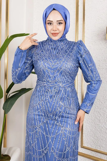 Woman wearing a blue beaded dress and hijab in a well-lit room.