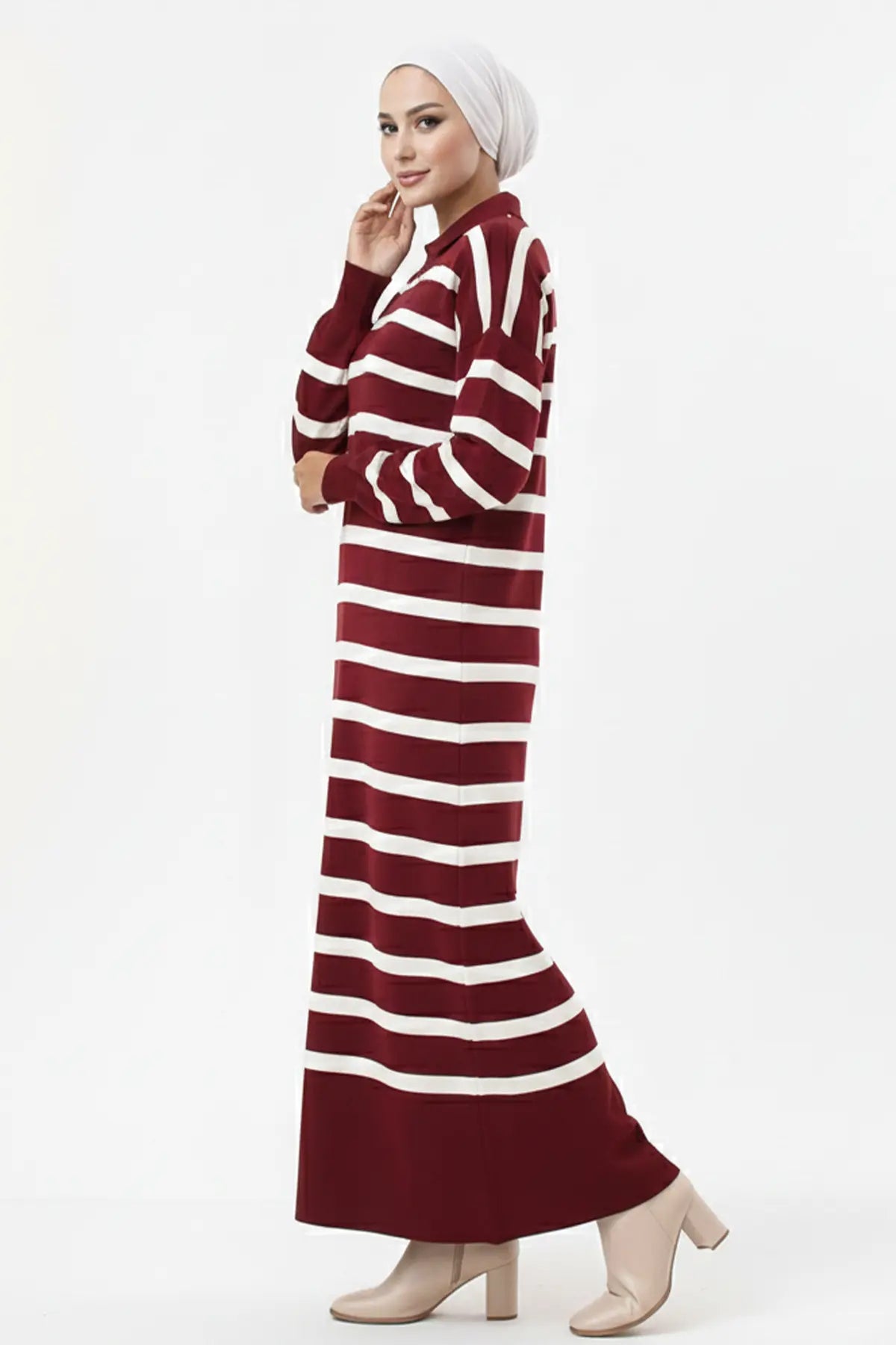 Woman wearing a maroon and white striped dress on a white background