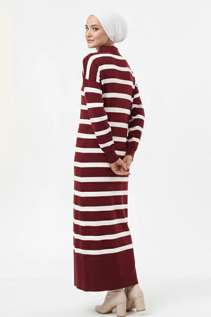 Person wearing a maroon and white striped dress on a white background