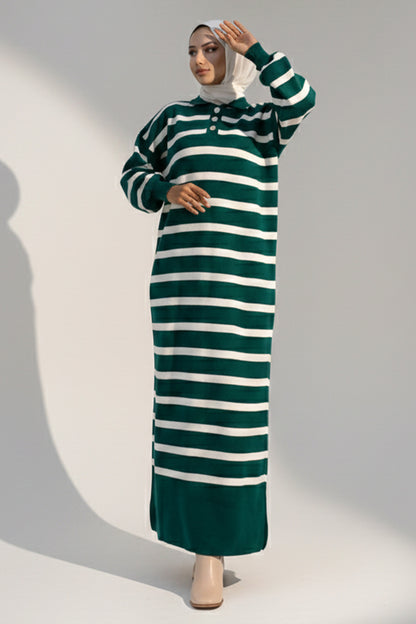 Woman wearing a green and white striped dress against a gray background