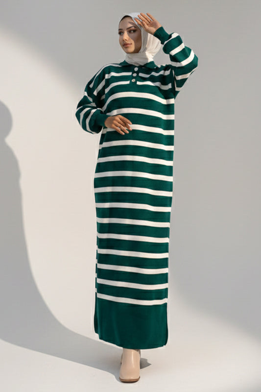 Woman wearing a green and white striped dress against a gray background